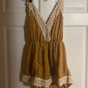 gold romper with lace. open back with ties